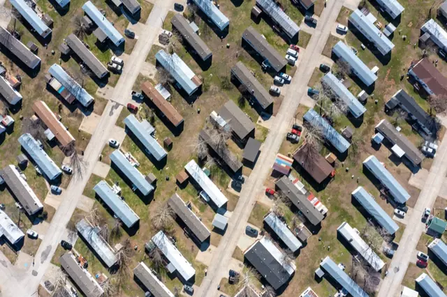 Aerial view of rows of homes and vehicles