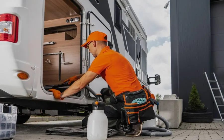 Technician servicing an RV storage bay
