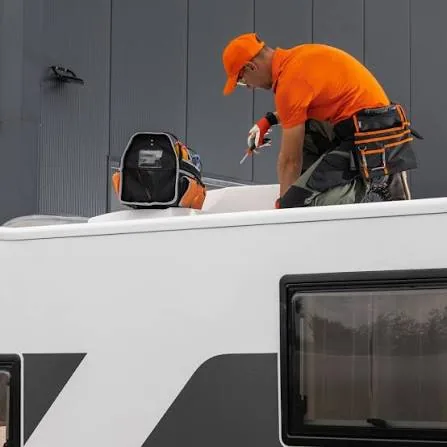 Technician repairing the roof of an RV